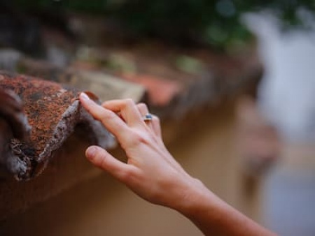 female-hand-gently-touches-weathered-tiles-2025-01-16-08-27-26-utc (1).jpg