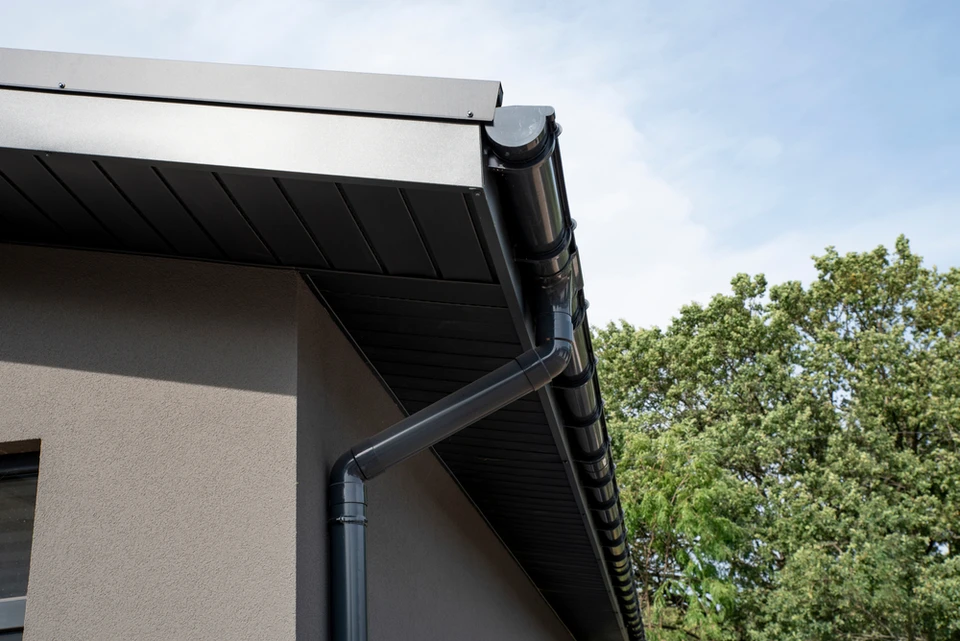 Extérieur d'une habitation moderne avec vue sur la toiture et système d'évacuation des eaux pluviales