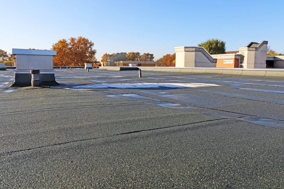 Toiture-terrasse commerciale en membrane EPDM noire avec joints d'étanchéité visibles